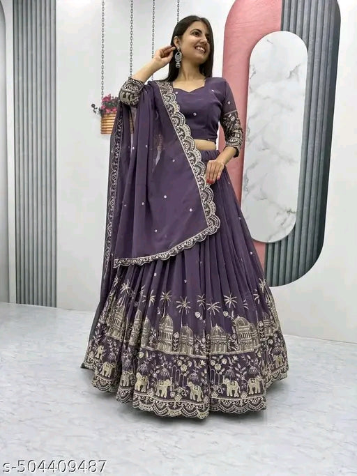Woman wearing a purple traditional outfit with intricate designs in a minimalistic setting.