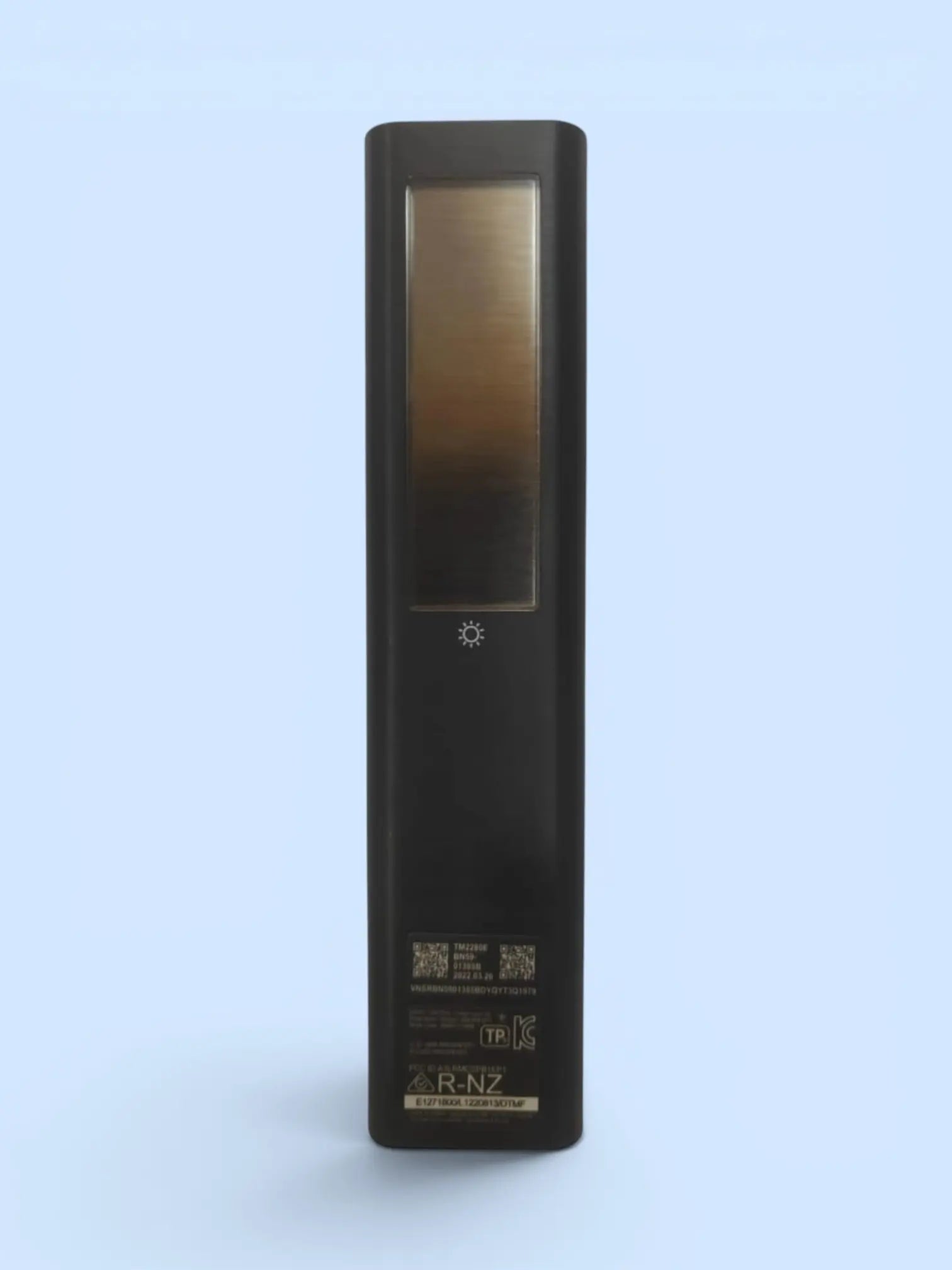Black electronic device with a reflective surface on a light blue background