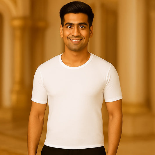 Man wearing a white t-shirt against a warm-toned architectural background