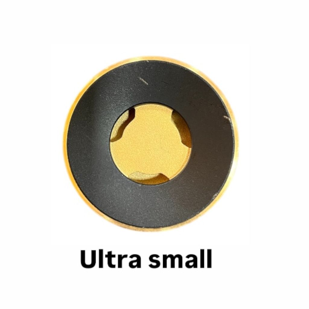 Technician checking fitment of Kaff brass burner cap on cooktop”