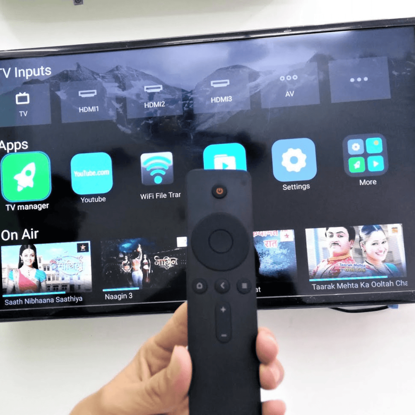 Original MI Smart TV Remote lifestyle — person using MI Android TV with original remote India