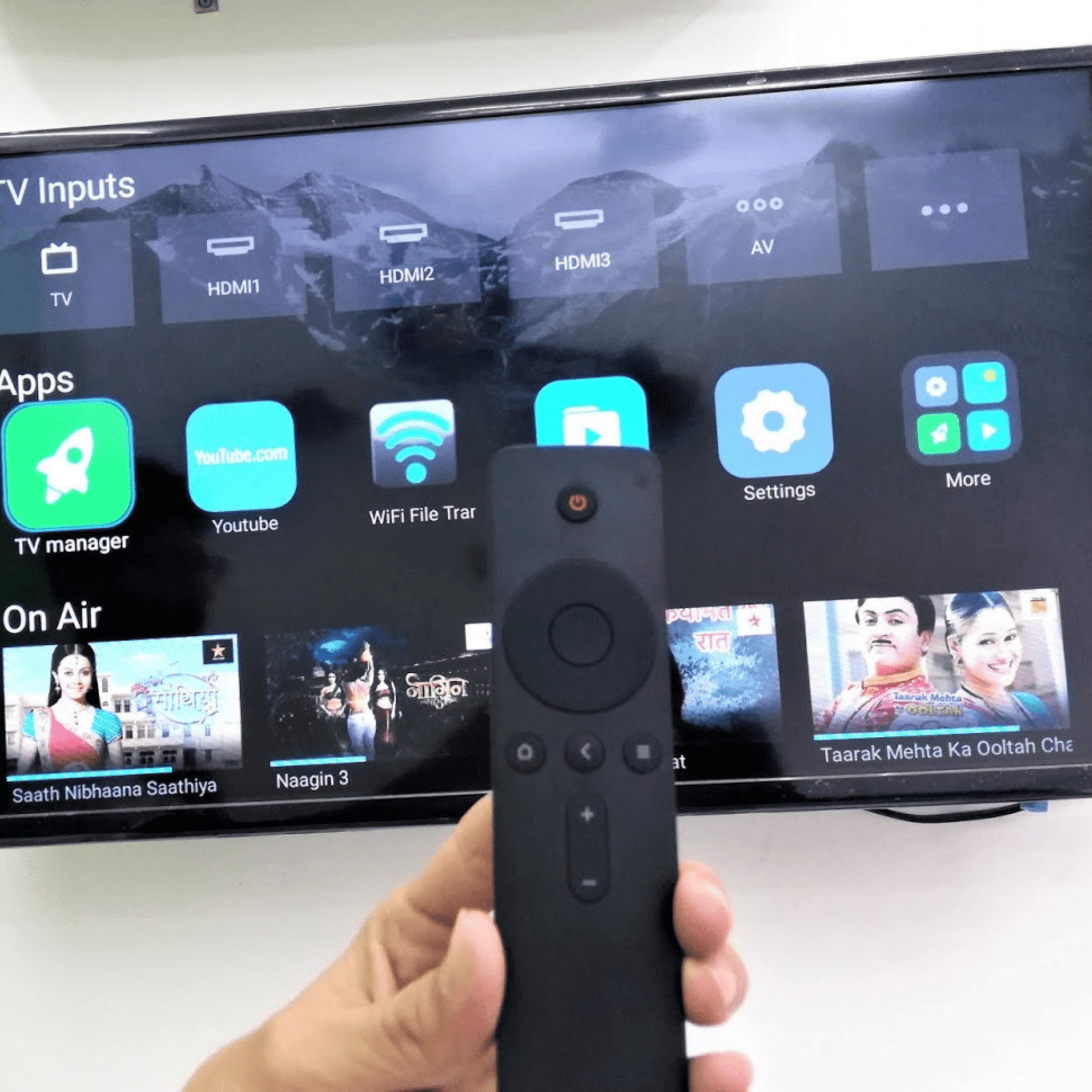 Original MI Smart TV Remote lifestyle — person using MI Android TV with original remote India