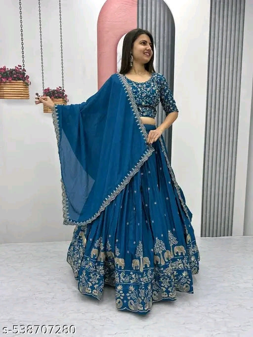 Woman wearing a blue traditional outfit with floral patterns on a white background
