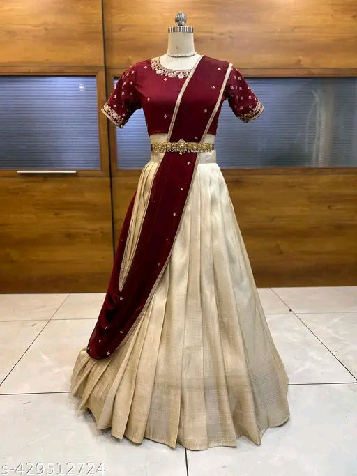 Maroon and beige traditional outfit on a mannequin against a wooden panel background