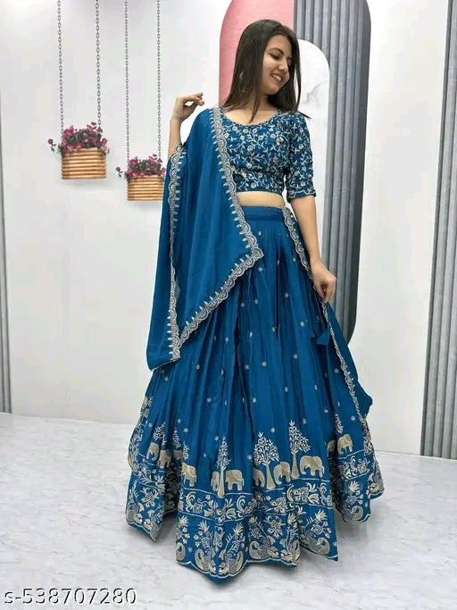 Woman wearing a blue embroidered traditional outfit with a white background