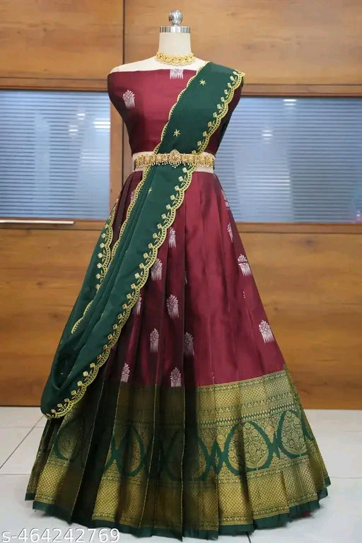 Maroon and green traditional outfit on a mannequin against a wooden background