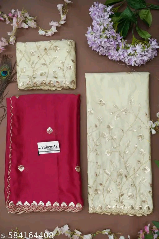 Embroidered fabric with a red fabric and 'Fabertz' label on a brown background with flowers.