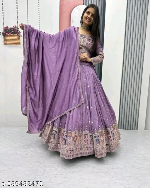 Woman wearing a purple traditional outfit with a matching dupatta indoors.