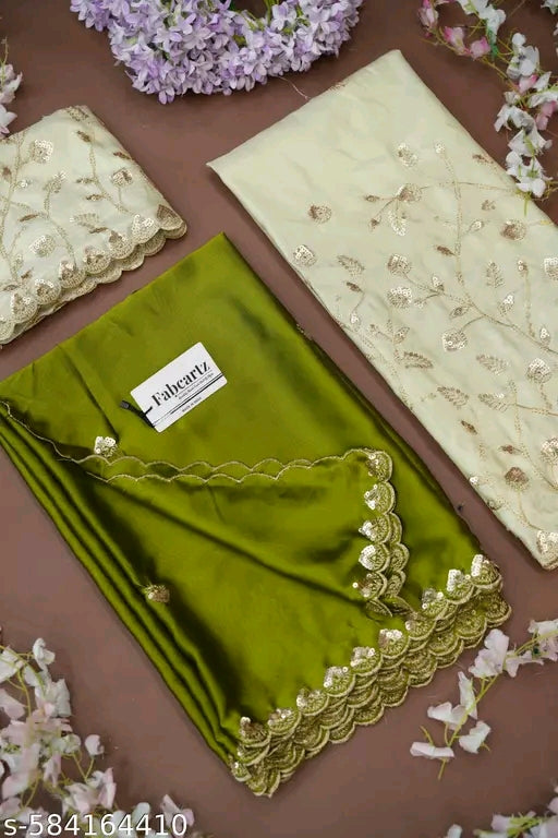 Green fabric with gold lace and a label on a brown background with flowers.