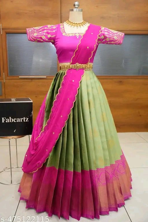 Traditional pink and green saree on a mannequin with a wooden background