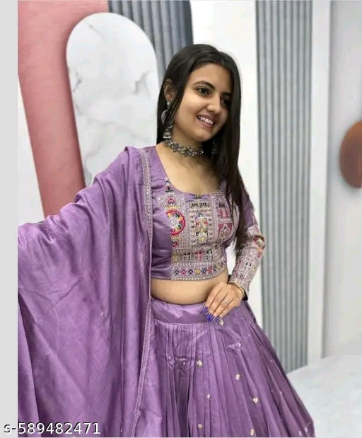 Woman wearing a purple traditional outfit with intricate designs.