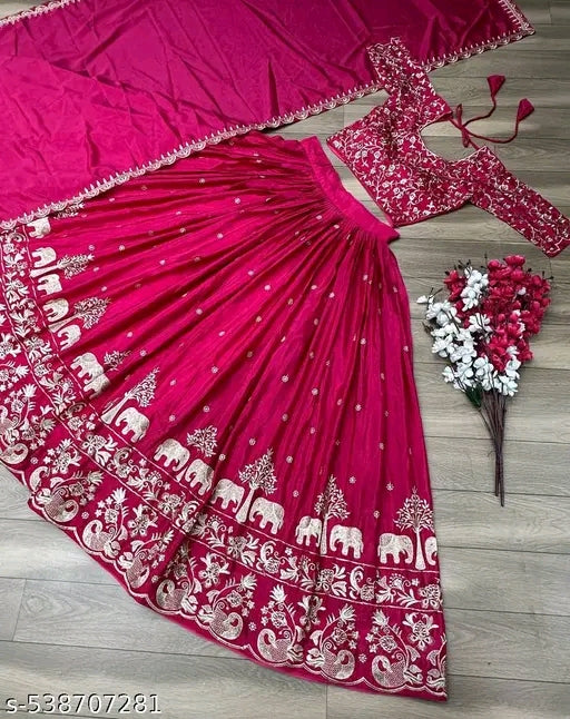 Pink saree with white patterns on a wooden surface