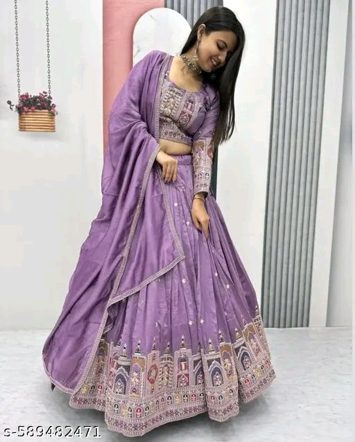 Woman wearing a purple embroidered saree with a matching blouse in a minimalistic setting.