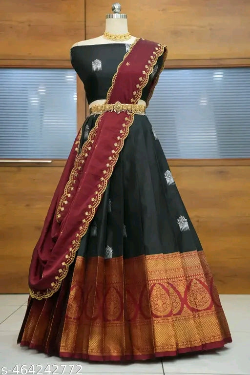 Black saree with maroon border on a mannequin against a wooden background