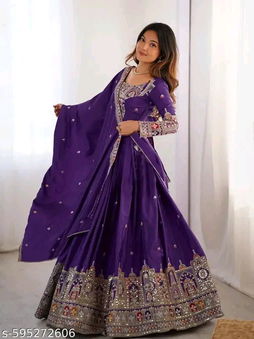 Woman wearing a purple traditional outfit with intricate designs against a white background