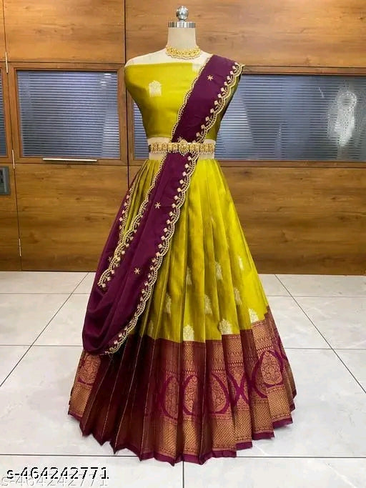 Yellow and maroon saree with gold border on a mannequin against a wooden background