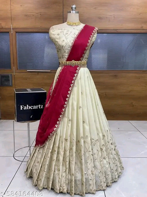 Mannequin wearing a cream and red traditional outfit with 'Fabcartz' branding in the background.