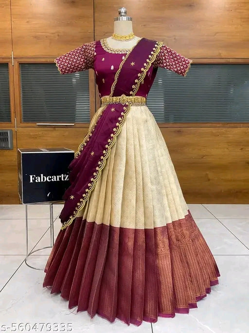 Traditional Indian saree with maroon and cream colors on a mannequin against a wooden background.