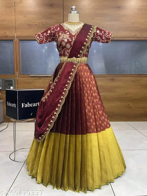 Maroon and yellow traditional outfit on a mannequin with a wooden background