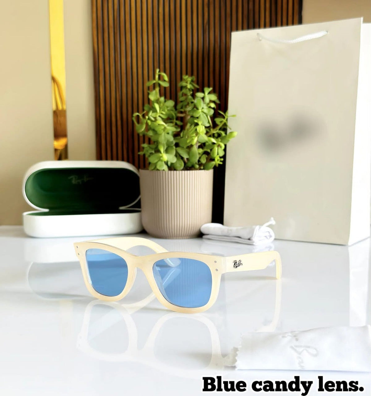 White frame sunglasses with blue candy lenses, case and packaging
