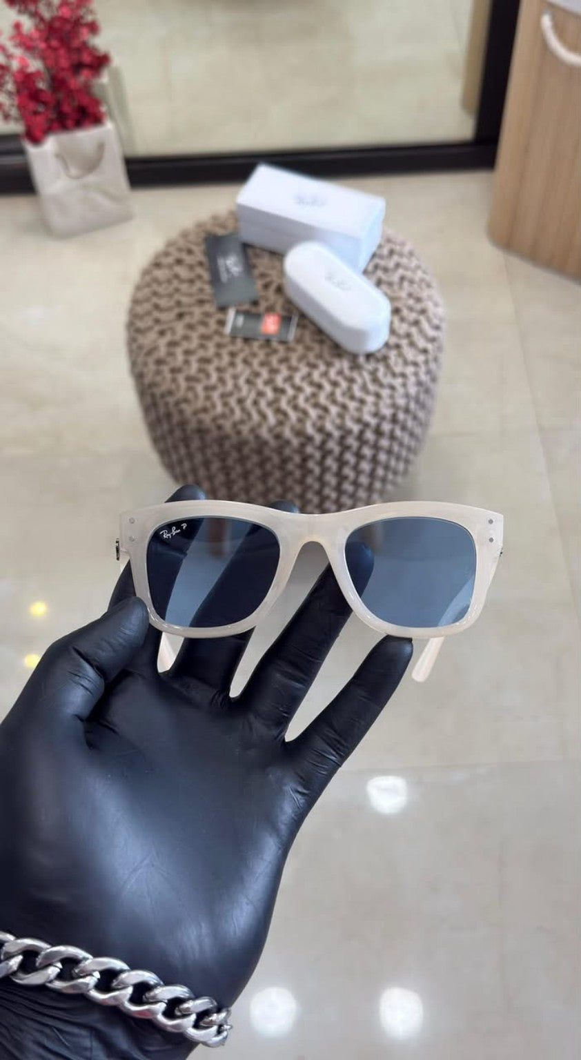 White-frame sunglasses with blue lenses and box