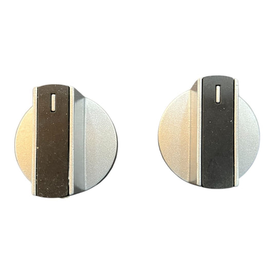 Front view of silver and black metal gas stove knob pair for cooktops