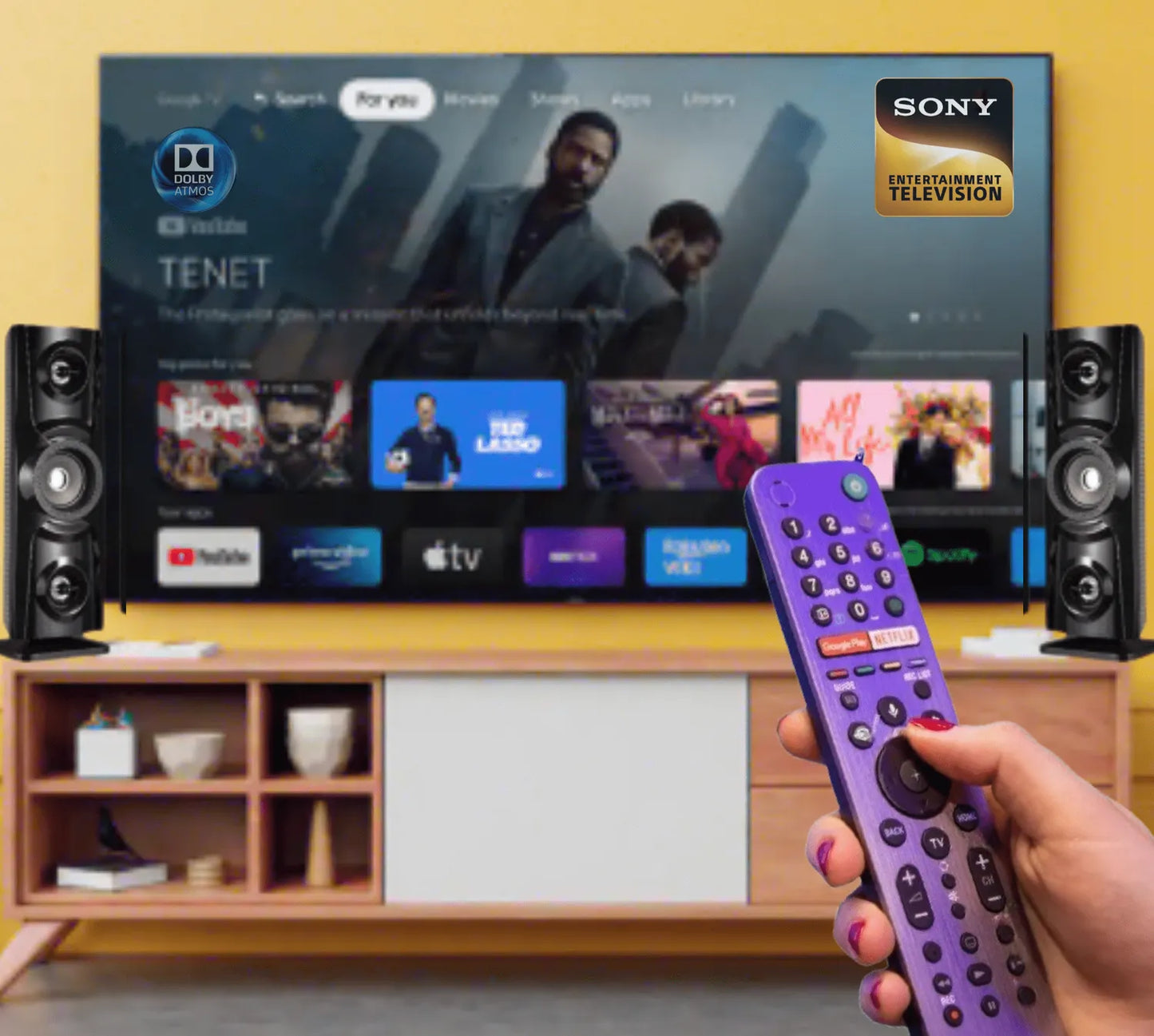 User operating Sony Smart TV with purple voice remote in front of streaming