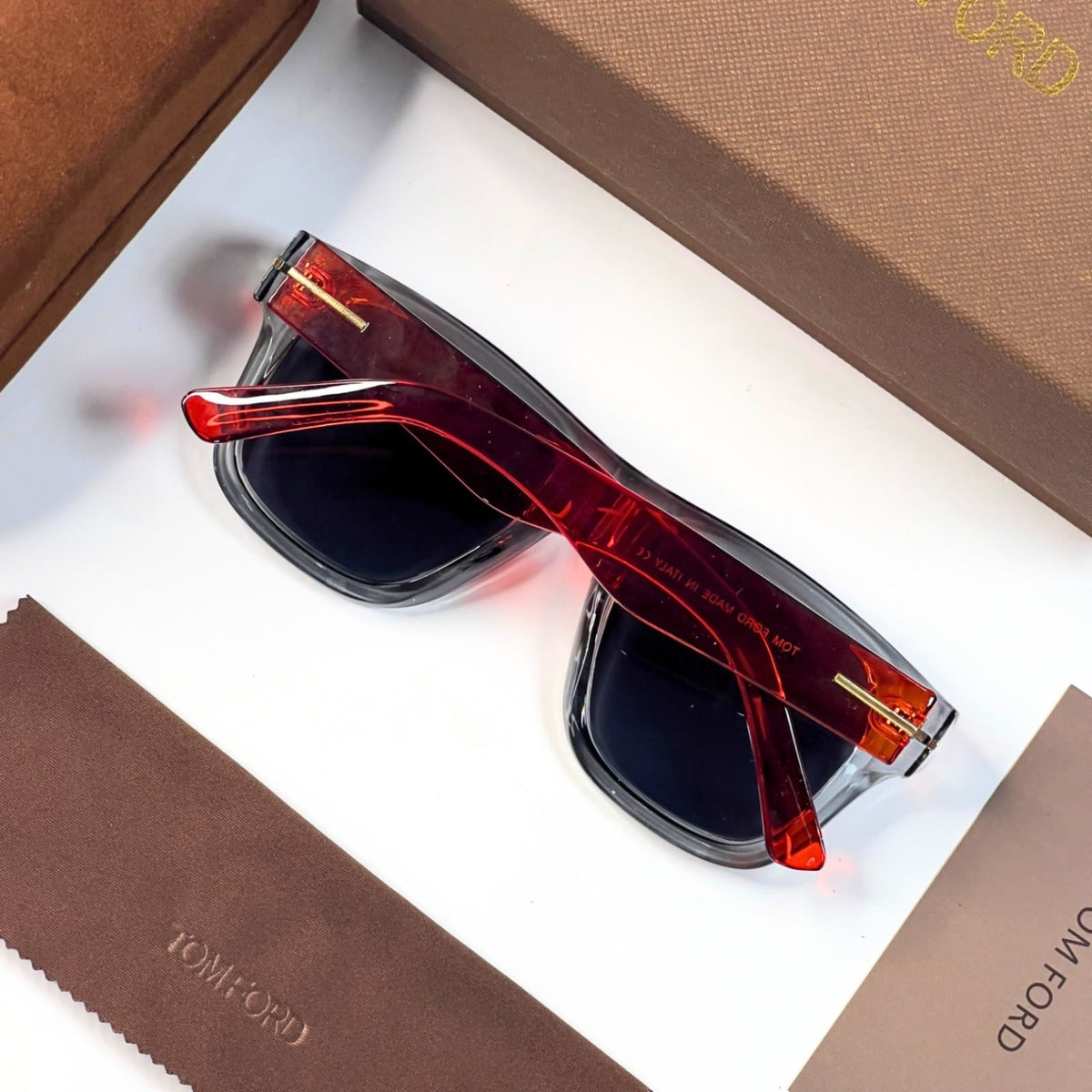 Tom Ford 259 sunglasses rear view with orange-red temples and dark lenses