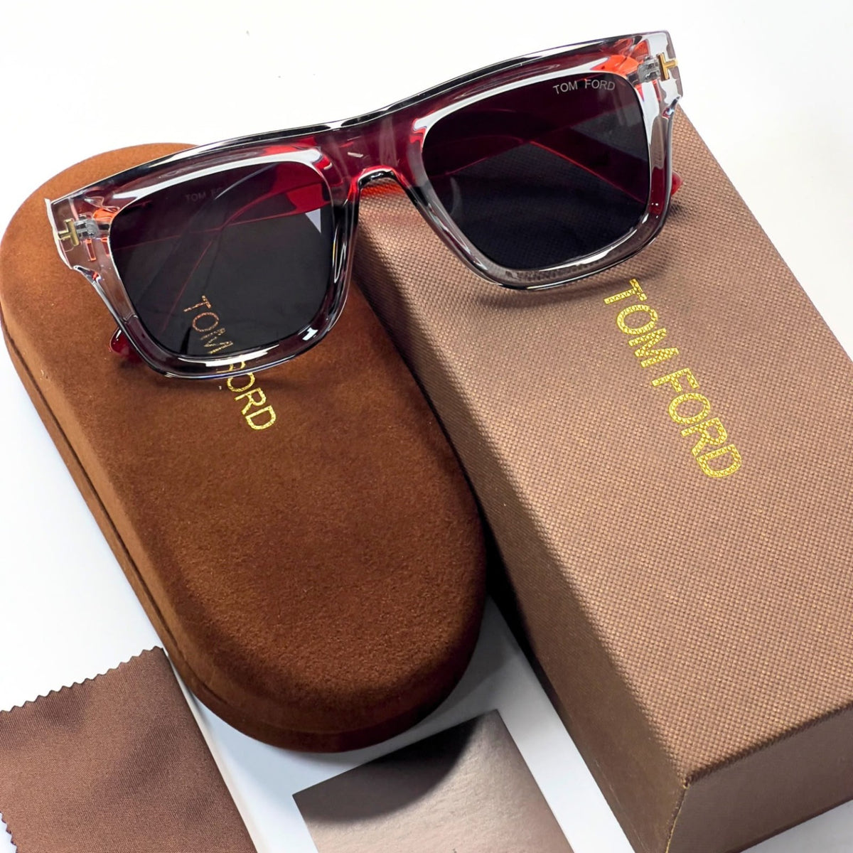 Tom Ford 259 sunglasses front view with transparent grey frame and dark lenses