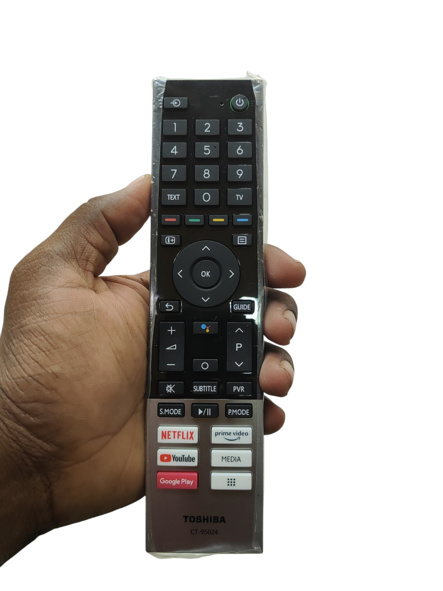 A hand holding a Toshiba Smart TV remote control with voice control, visible buttons include Netflix, Prime Video, and YouTube.