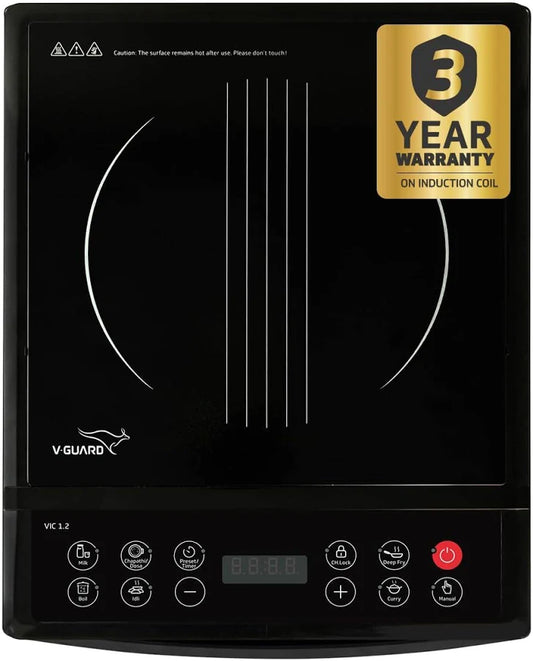 Black induction cooktop with V-Guard branding and 3-year warranty on induction coil label.